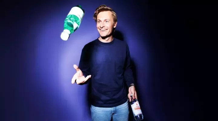 man throwing bottle in the air
